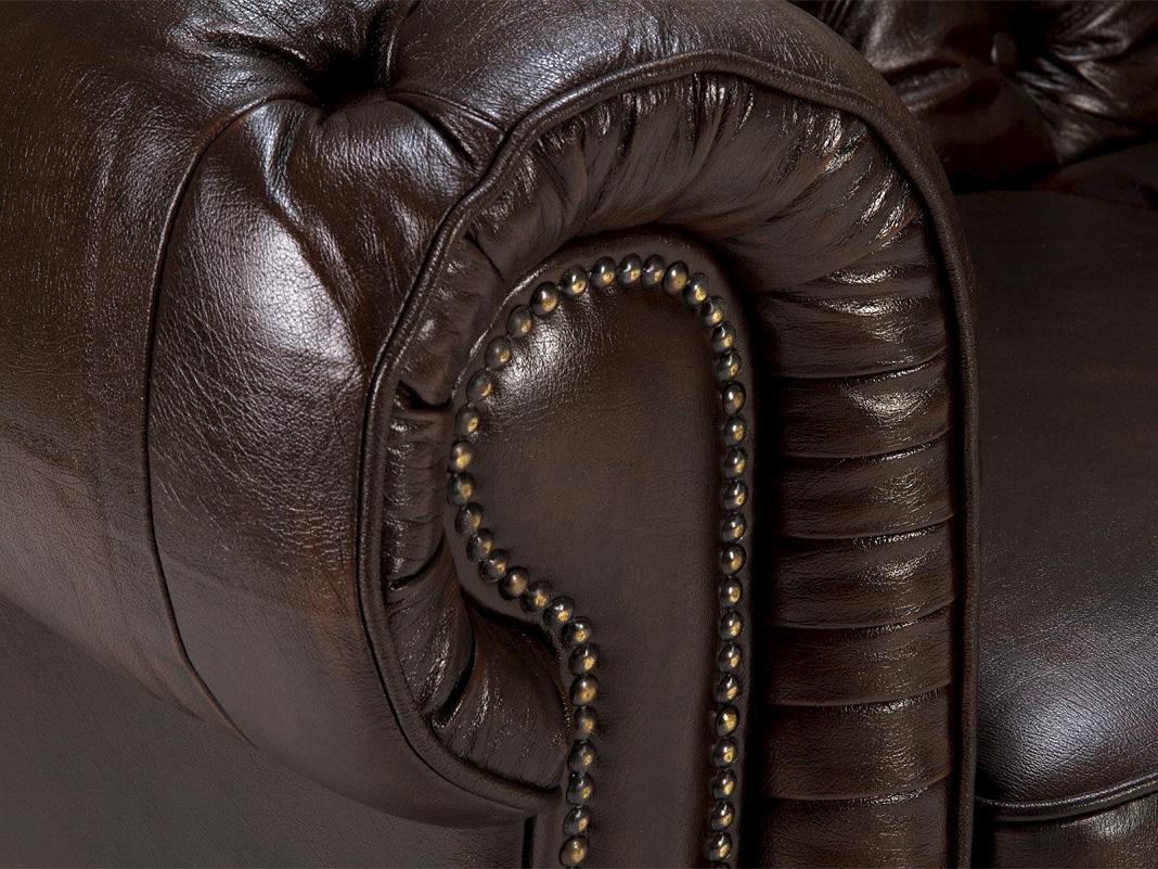 Ledergarnitur mit Nietenbesatz im Vintage-Look, sichtbare Metallnieten an den Kanten, gemütliches Wohnzimmerambiente